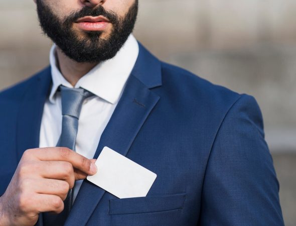 close-up-man-holding-business-card_23-2148479527